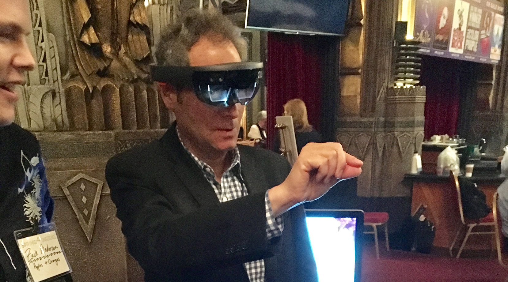 Member Van Kaplan tries out a virtual reality tool offered by sponsor Apples and Oranges Arts.